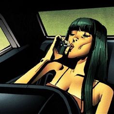 a woman sitting in the back seat of a car drinking from a cup