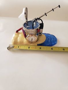 a measuring tape and clock sitting on top of a table