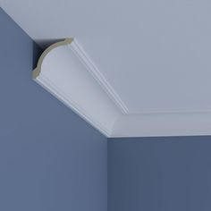 the corner of a room with blue walls and a light fixture on the ceiling above it