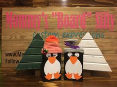 two penguin boxes sitting next to each other on a wooden sign that says winter brown's shop