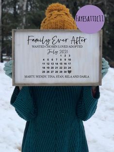 a person holding up a sign that says family ever after, with the date on it