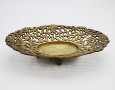 an ornate brass bowl on a white background