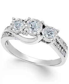 three stone engagement ring with diamonds on the shoulders and side stones set in white gold