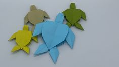 three origami fish are sitting next to each other