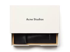 an open box with some sort of black object in it that says acne studios