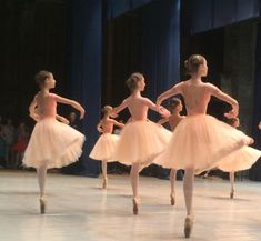 several young ballerinas in tutu skirts on stage