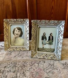 two framed pictures are sitting on the floor next to each other, one has a woman's face