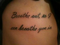 a tattoo saying breathe out, so i can breathe you in on someone's back