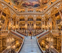 an ornate building with many stairs and chandeliers