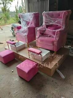 pink chairs and foot stools are stacked on top of each other