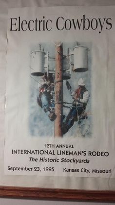 an advertisement for electric cowboys hangs on the wall