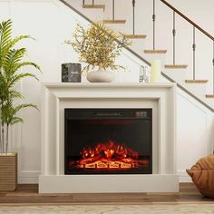 a white fireplace with an electric fire in the center and stairs leading up to it