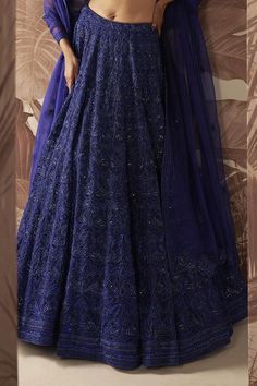 Indigo blue lehenga with bead and crystal embellished floral motifs. Comes with embellished blouse and dupatta.
Components: 3
Pattern: Embroidered
Type Of Work: Sequin,Crystal
Neckline: V-neck
Sleeve Type: Sleeveless
Fabric: Blouse and Lehenga: Net, Dupatta: Organza 
Color: Blue
Other Details: 
Bead tasselled blouse
Closure: 
Lehenga: Side Drawstring
Blouse: Side zip
Occasion: Bride,Wedding - Aza Fashions Blue Embellished Sharara For Reception, Fitted Blue Embellished Traditional Wear, Fitted Embellished Blue Traditional Wear, Blue Embellished Floor-length Saree, Embellished Blue Choli, Blue V-neck Sets With Resham Embroidery, Semi-stitched Embellished Blue Saree, Blue Embellished Bollywood Choli, Traditional Blue Embellished Sharara