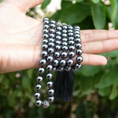 "📿This Balancing Mala is hand-knotted with the finest Hematite Beads. Each Bead is mindfully knotted with love, one at a time on a durable nylon silk cord for extra strength and durability. This Mala features all 108 beads divided by markers into sections of beads that follow a selected pattern. Each section is marked with an Oxidized Silver Metal Marker Bead. It is finished with a Silk Tassel adorned with silver Zari. The tassel symbolises consciousness and oneness. This Mala helps varying ene Silver Beaded Necklace With Round Beads, Silver Mala With Round Beads For Meditation, Silver Mala With 108 Beads As Gift, Silver Mala With 108 Beads For Meditation, Silver Beaded Necklace For Meditation With 8mm Beads, Hematite Bead Necklaces As Gifts, Hematite Beads For Gifts, Hematite Bead Necklace As A Gift, Black Hand-knotted Jewelry With Round Beads