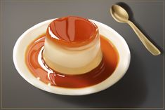 a spoon and sauce in a white bowl on a gray surface with an orange liquid