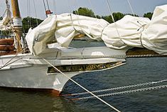 the sailboat is covered with white tarps