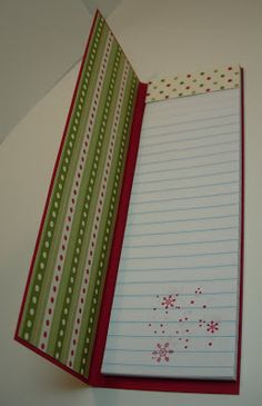 an open notebook with lined paper and snowflakes on the cover, sitting on a table