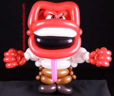 an inflatable balloon character is posed on a black background