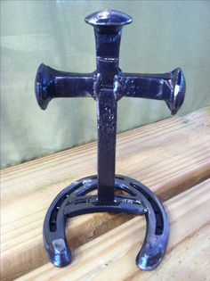 a black iron candle holder on top of a wooden table