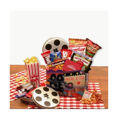 a movie themed gift basket with popcorn, movies and other snacks on a checkered tablecloth