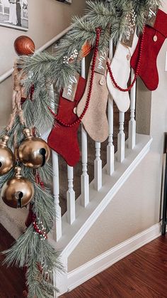 christmas stockings hanging on the banisters and ornaments