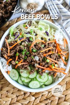 a bowl filled with beef, carrots and cucumbers on top of rice