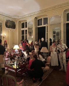 a group of people standing and sitting around a living room