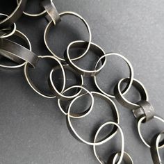 "This was an exercise on repetition, volume and forming just using my hands. It measures 24\" and comes without a clasp. It is made from alpaca or \"nickel\" silver, once it has been oxidized for contrast, brushed in light streaks and waxed the result is a matte dark surface which will not change color with wear. This is quite the statement piece and needs little else if you are one to wear strong pieces of jewelry this one is for you. Ready to ship and packed in a ready for gift giving in a eco Light Streaks, Handmade Chain, An Exercise, Wide Band Rings, Nickel Silver, Delicate Jewelry, Small Rings, Long Black, Cultured Pearls