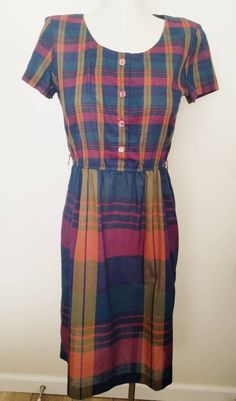 "Vintage dress Circa 1980s  By Lisa II Feels like lightweight cotton Simple Plaid shirtwaist dress Plumb, navy, tan and olive  Small plaid bodice Large plaid skirt Elastic waist Button front bodice Excellent vittage condition Measured flat: Pit to pit 20\" Across waist 12 -14\" Across aprox hips 22\" Pit to waist 8\" waist to hem 25.5\"" Star Blazers, Shirtwaist Dress, Velvet Blazer, Wiggle Dress, Plaid Skirt, Collar Blouse, Lovely Dresses, Plaid Skirts, Vintage Dress