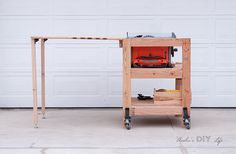 a workbench with tools on it in front of a garage door