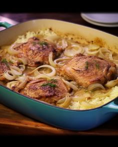 a blue casserole dish filled with meat and noodles