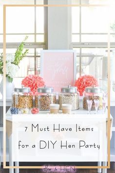 a white table topped with lots of jars filled with different types of food and flowers