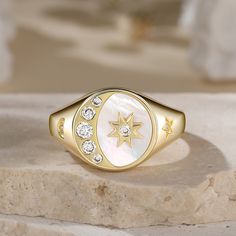 The crescent moon and star is one of our world's most ancient symbols, combining powerful icons joining man and woman. The star represents the female principle, and celebrates the cosmic powers of the love Goddesses Venus. This signet ring captivates us with its sparkling diamond and gold tone details. We love that it is bursting with celestial wonder!Carat Weight: 0.544 ctStone Size: 1.3,1.5,1.7,2.1,2.5 mmStone Type: Jeulia® StoneNumber of Stones: 9 Stone Shape: RoundStone Color: Diamond WhiteW Cosmic Powers, Crescent Moon And Star, Pre Black Friday, Sparkling Diamond, Moon And Star, Ancient Symbols, Diamonds And Gold, Moon Star, Opal Ring