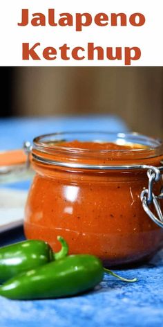 jalapeno ketchup in a glass jar next to a green pepper