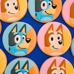 some cookies with cartoon characters on them are arranged in the shape of dogs and cats