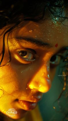 a close up of a woman's face with water all over her body and eyes