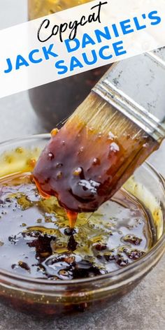 a person pouring sauce into a glass bowl with a spatula on it and the words, copycat jack daniels sauce