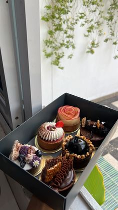 a box filled with lots of different types of cakes