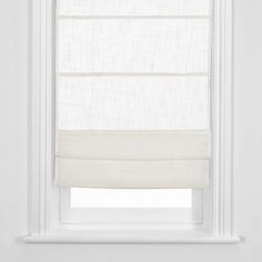 a white roman blind hanging on the side of a window