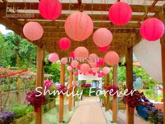 pink lanterns are hanging from the pergolated roof