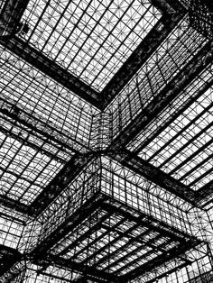 black and white photo of the ceiling in a building with many square glass panels on it