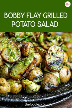 a black plate topped with grilled potatoes and broccoli