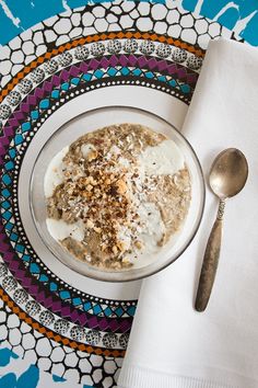 a bowl of oatmeal on a plate with a spoon