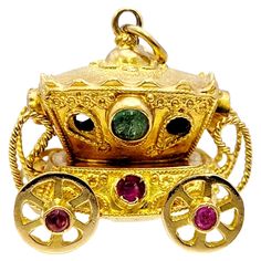 Unique multi-gemstone carriage charm/pendant with incredible fine details. The perfect addition to your favorite charm bracelet or necklace, this lovely piece is a miniature work of art. This charming piece features an intricately carved 18 karat yellow gold carriage with 4 rolling wheels that all move. The pendant with is embellished with a single natural diamond (G / VS1), 3 natural emeralds and 3 natural rubies, adding a pop of color as well as a touch of sophistication. This listing is for the pendant/charm only, no necklace or cord is included, however the 5 mm bail opening can accommodate a variety of sized chains to personalize and make your own. The incredible craftsmanship and elaborate detail work, including the tiny windows and twisted ropes, will make this piece a truly special Gold Carriage, Vintage Carriage, Natural Emerald, Diamond Clarity, Charm Pendant, Colored Diamonds, Natural Diamonds, Jewelry Necklace Pendant, Diamond Cuts