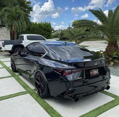 a black sports car parked in front of a house