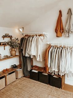 an organized closet with clothes and shoes hanging on the wall, baskets under it and shelves below