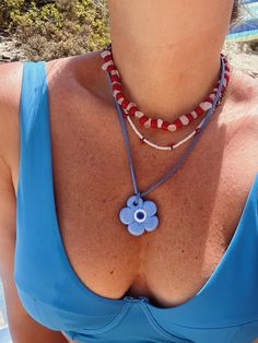 Our stunning chillax blue flower evil eye necklace is a beautiful and unique piece that perfectly combines elegance and charm.     featuring a hand-painted glass it showcases symbols of "luck" "protection" and "joy" embodying inner wisdom and positive manifestation.   it's not just an accessory; it's a conscious choice to align with your desired energies.     wear it solo or layered; the flower evil eye bead whispers tales of resilience and hope guiding you toward your own inner light.    the pendant hangs from a soft 100 cm long vegan suede string offering both comfort and style.    this versatile piece can be worn around your neck waist or even as a chic accent on a bag.    suede cord approx. 100 cm (39.37" )  glass evil eye flower pendant size: 4 cm (1.57" )    care    avoid contact wit Handmade Flower Pendant Jewelry For Beach, Bohemian Summer Necklace With Flower Pendant, Bohemian Flower Pendant Necklace For Summer, Adjustable Flower Pendant Necklace For Summer, Handmade Flower Pendant Necklace For Summer, Blue Bohemian Flower Beaded Necklaces, Blue Flower Jewelry For The Beach, Blue Flower-shaped Jewelry For The Beach, Bohemian Blue Flower Necklace