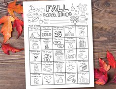 a fall book bingo game with leaves around it