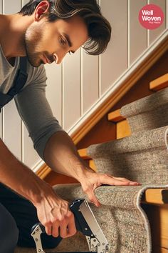 a man is working on carpeting with a pair of scissor attachments