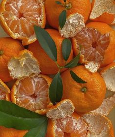 an arrangement of oranges with leaves on them